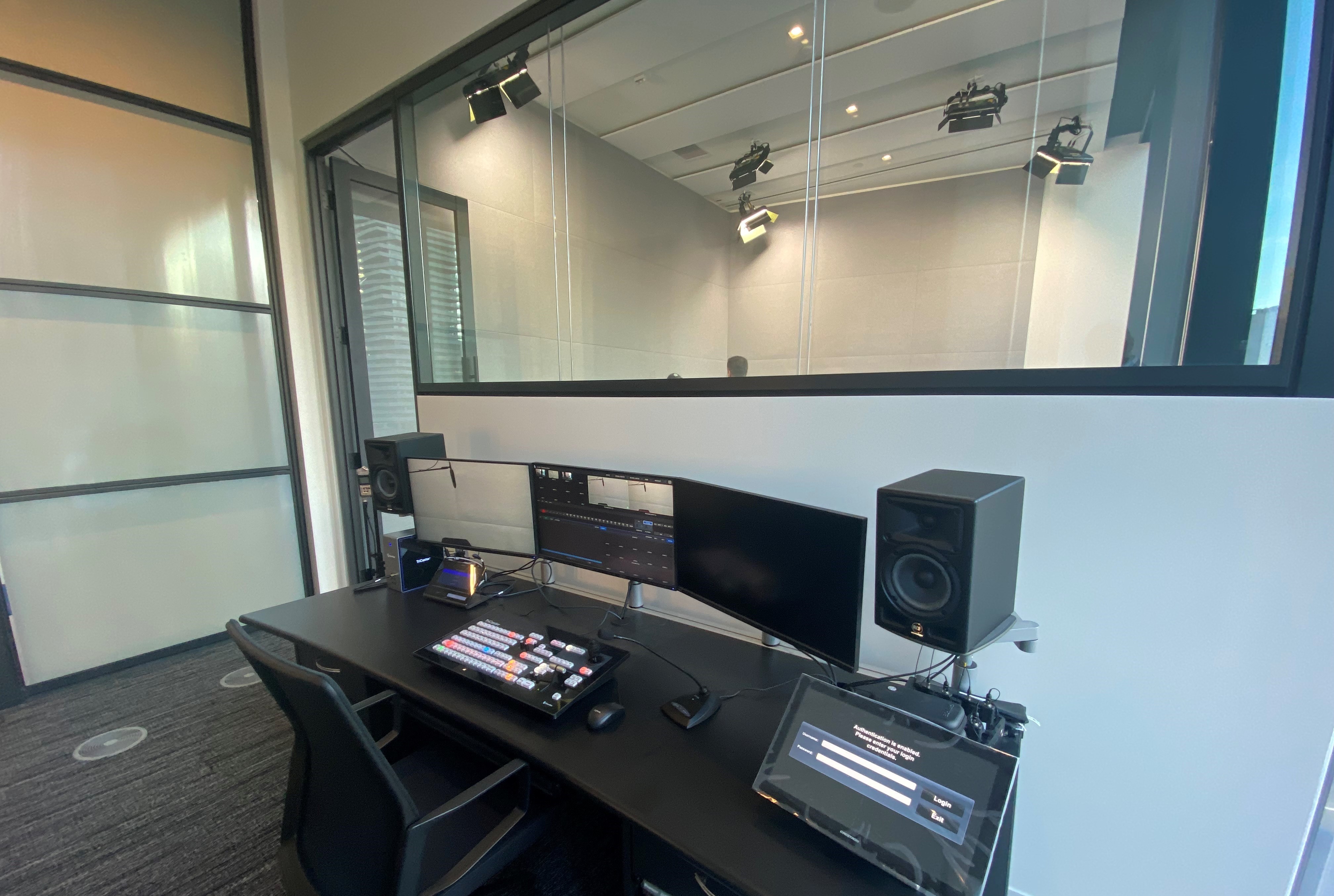 In-house digital production studio featuring audio board and recording booth